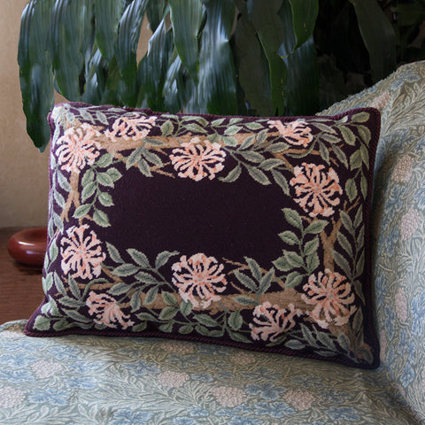 Honeysuckle Border stitched as a cushion with a mauve background